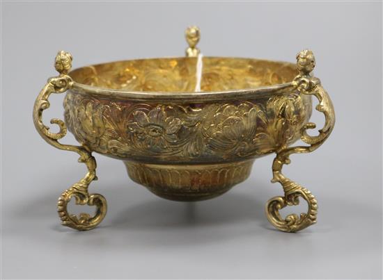 A George V silver gilt tri-handled floral embossed circular bowl by Daniel & John Welby, London, 1911, 9 oz.